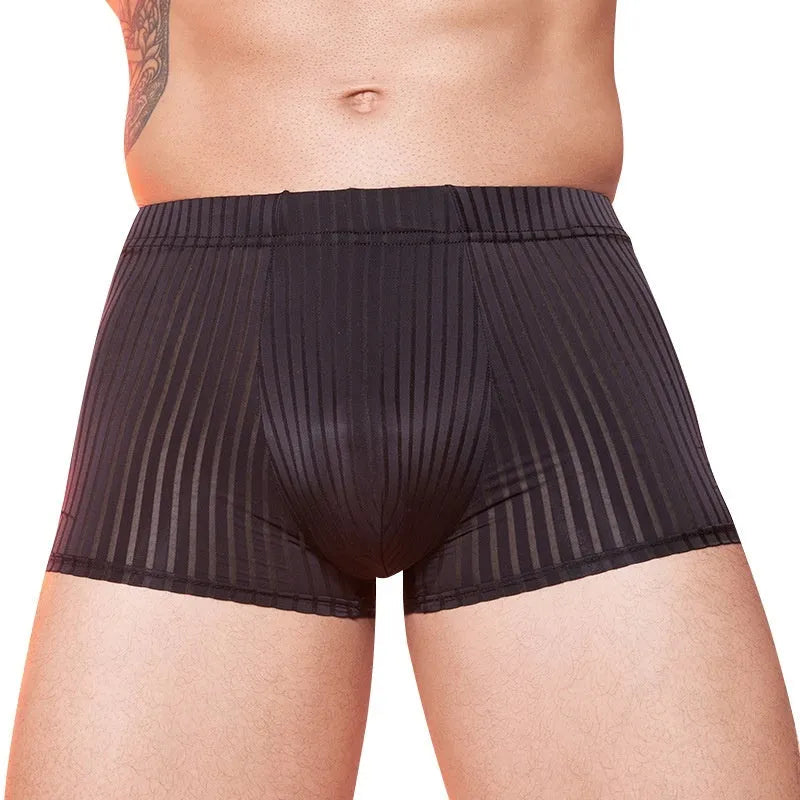 Men's black and white striped low-rise nylon briefs on a flat surface