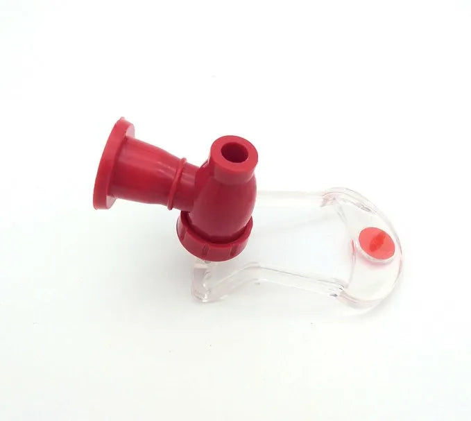 Red plastic soda dispenser attached to 2-litre bottle showing push-button mechanism