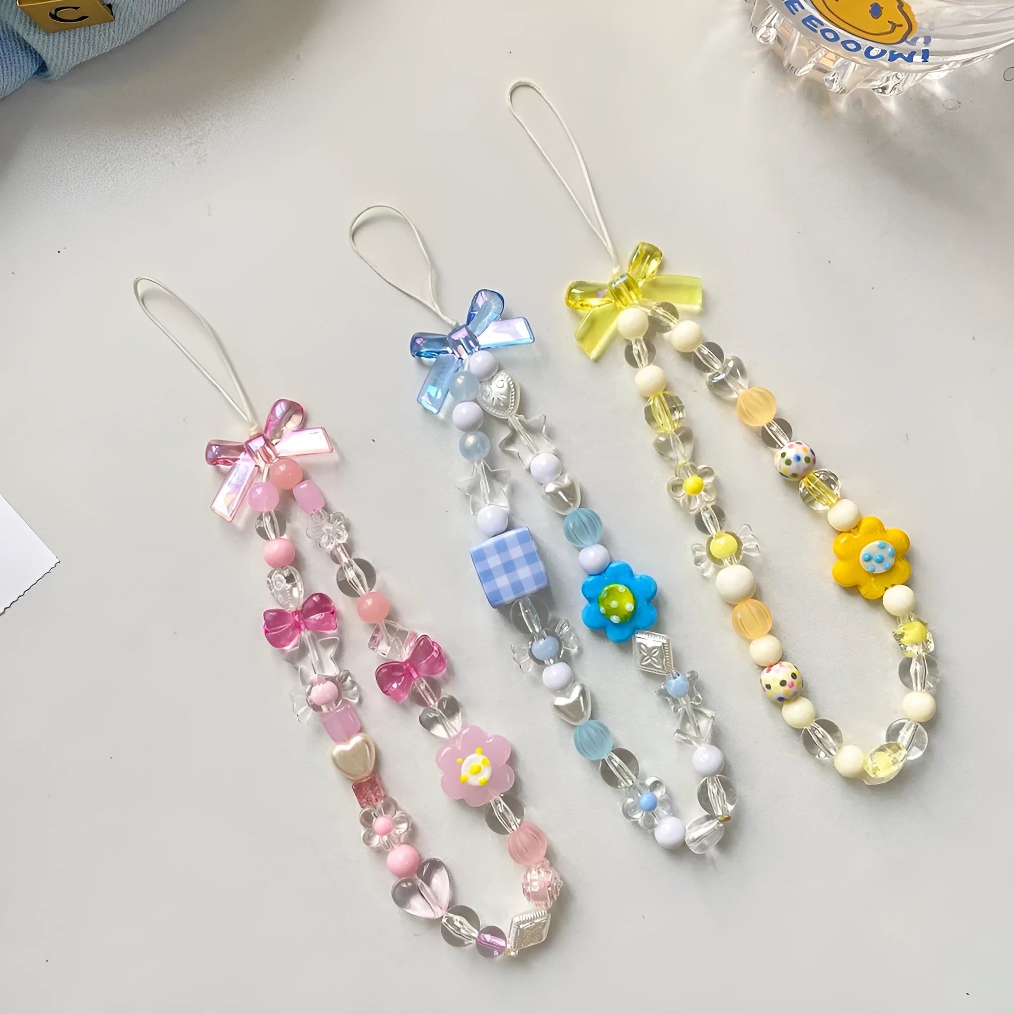 Beaded flower mobile phone lanyard with plastic resin decorations in blue, pink or yellow colour options
