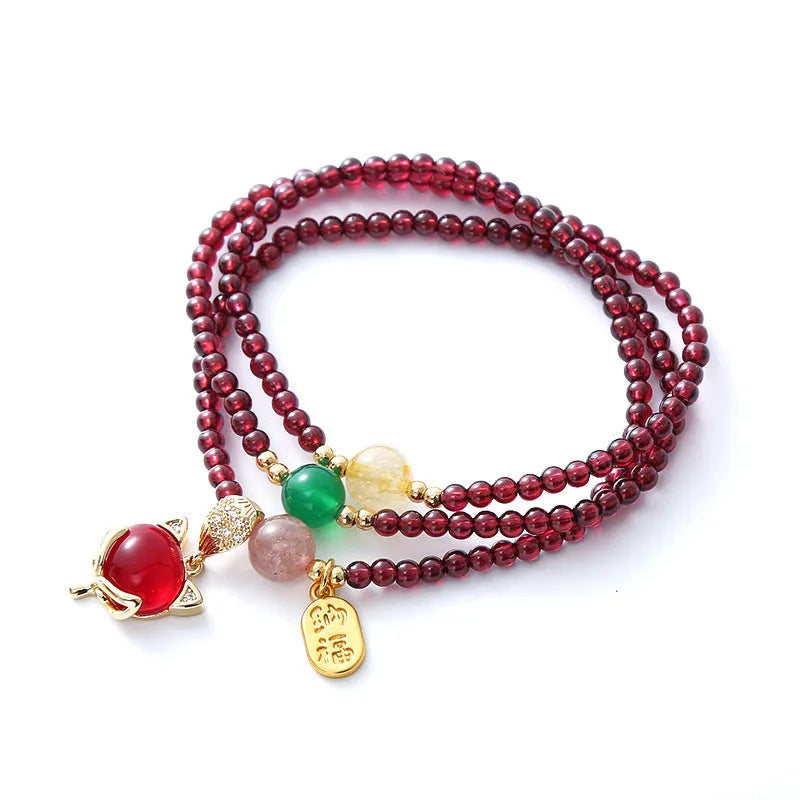 Purplish red garnet crystal bracelet with fox charm and adjustable rope