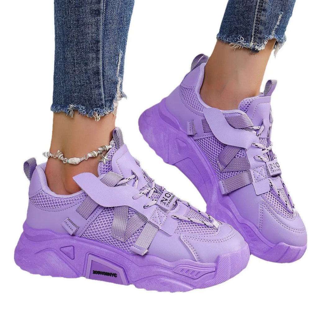 Women's purple platform sneakers with breathable mesh upper and white sole on a plain background.