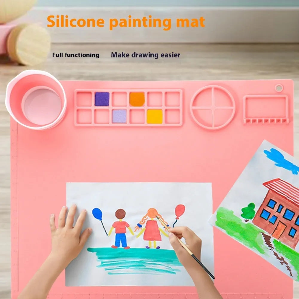 Light blue silicone painting mat with two built-in bowls, sized 50 by 40 centimetres.