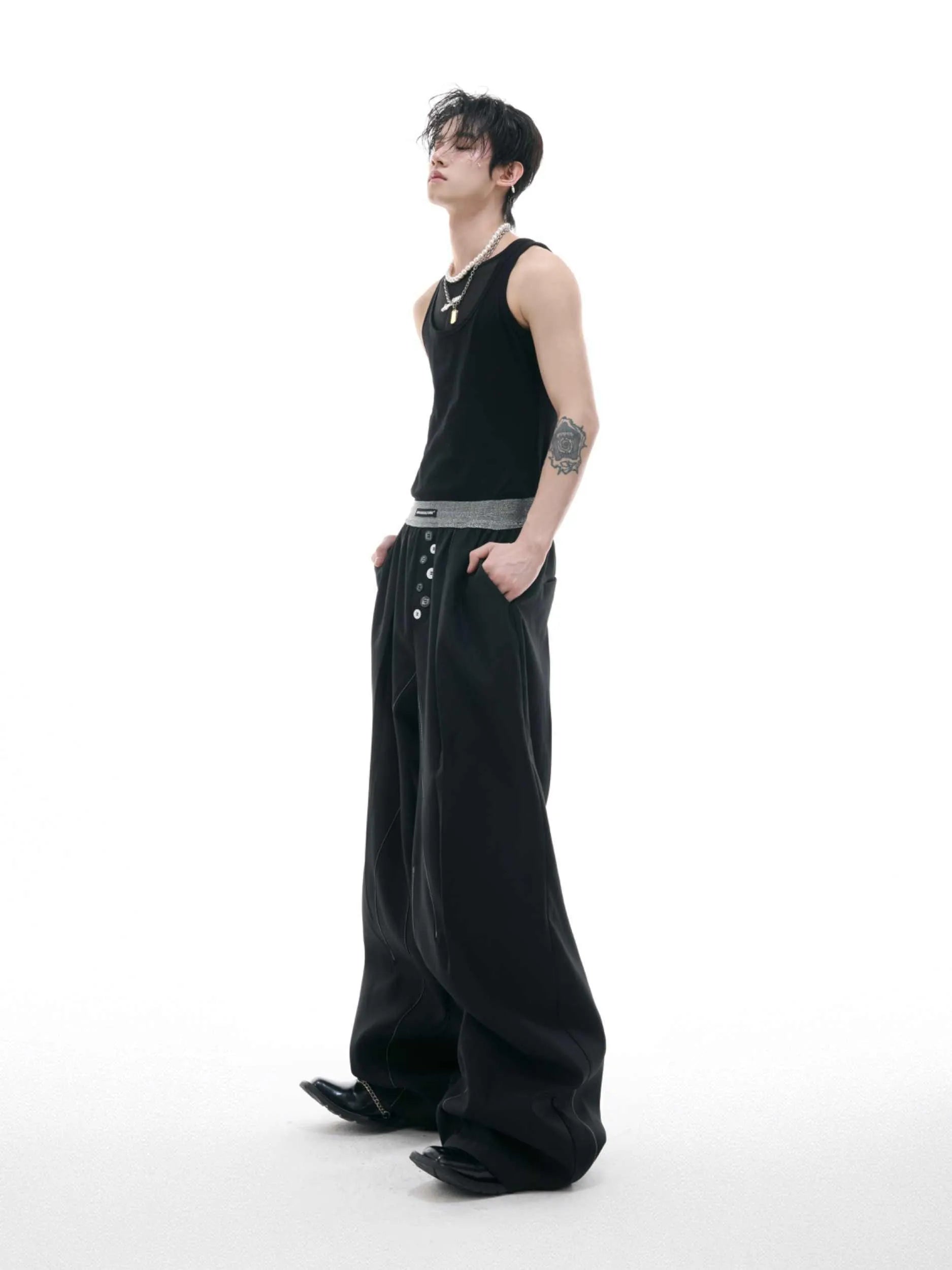 Drooping straight-leg suit pants in black with button open line design and high-waisted fit