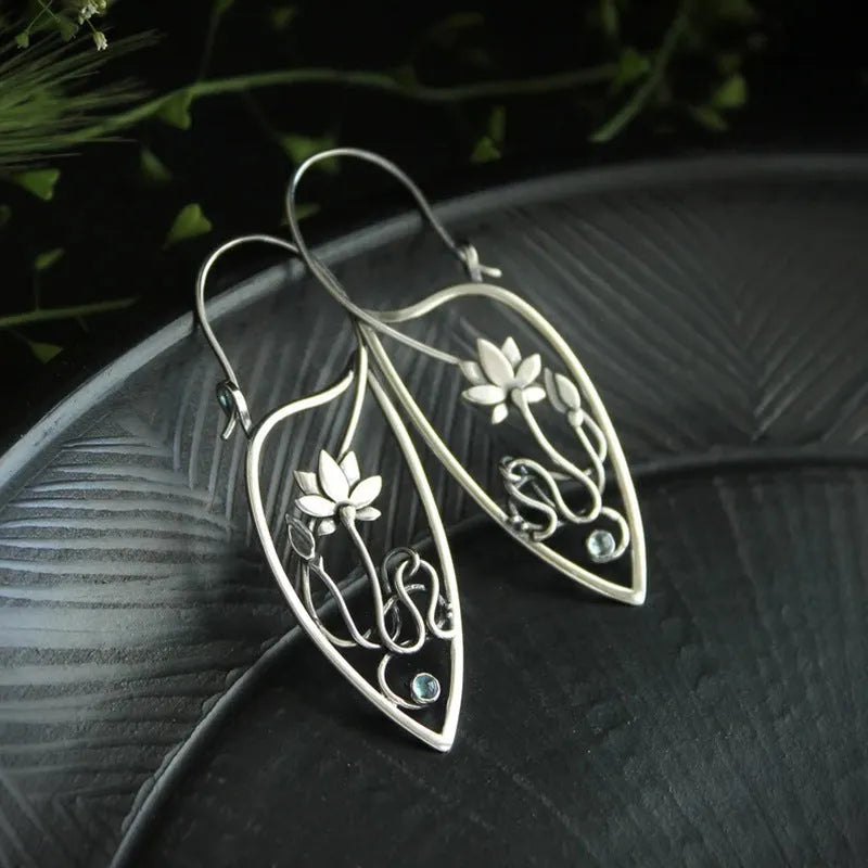 Silver lotus vine and geometric flower design earrings with rhinestone decoration on alloy base