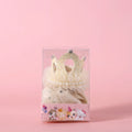 Beige and pink princess crown headdress with veil for cats on a plain background.