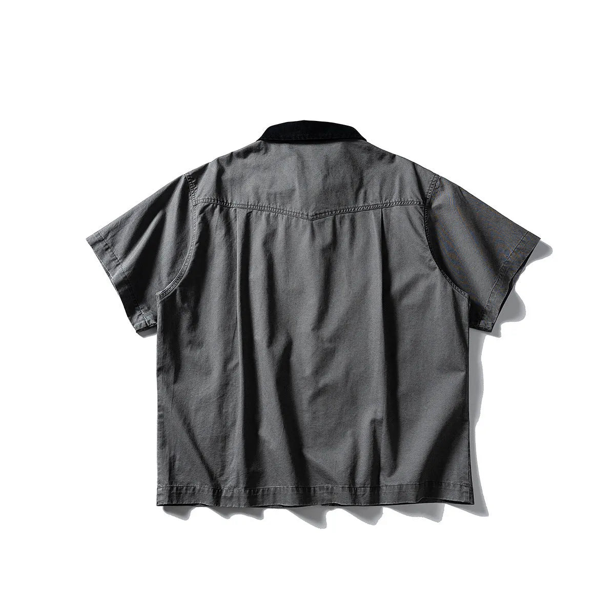 Man's loose-fitting khaki cotton overalls shirt with short sleeves, cardigan style