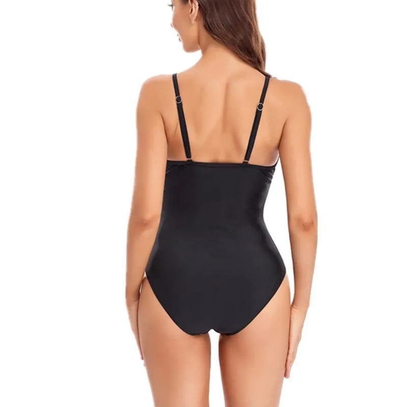 Women's solid colour backless one-piece swimsuit made from spandex on a neutral background.