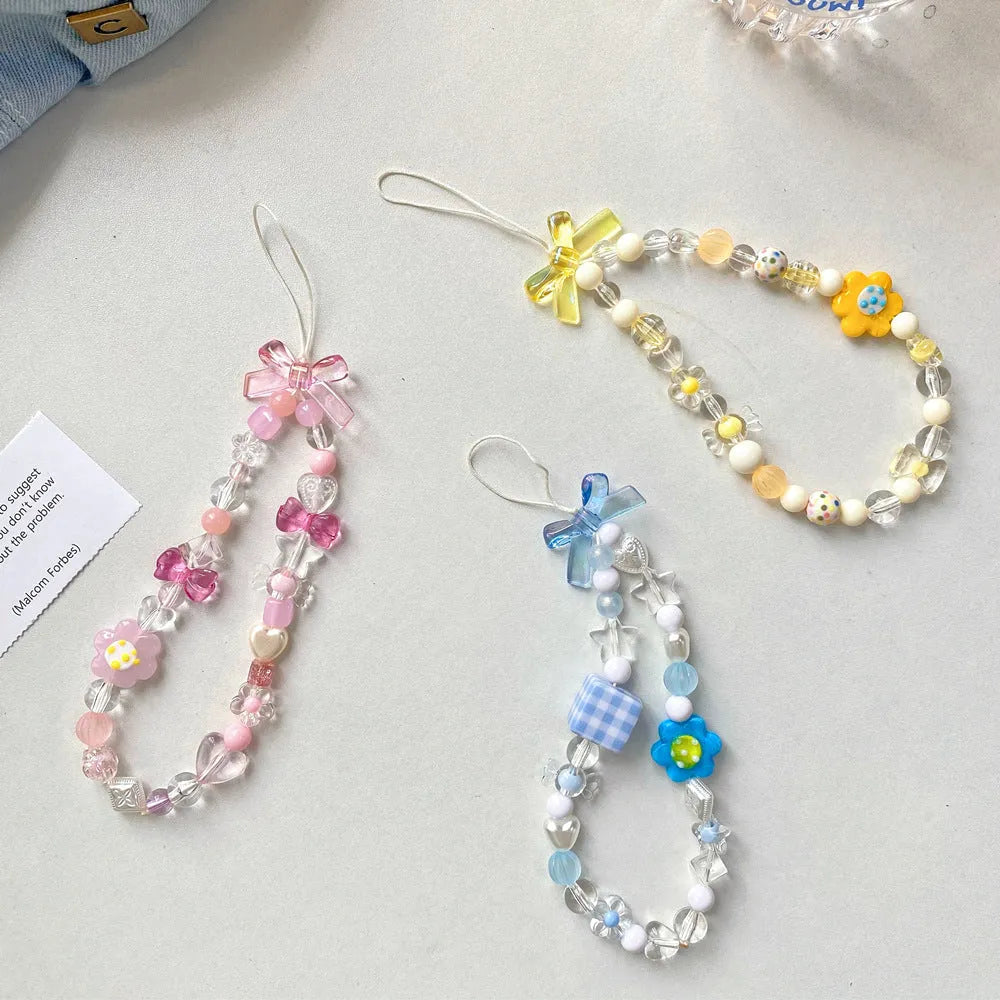 Beaded flower mobile phone lanyard with plastic resin decorations in blue, pink or yellow colour options