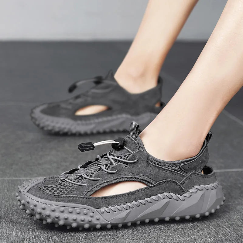 Men's black outdoor sports sandals with leather mesh upper and rubber sole showing elastic band closure