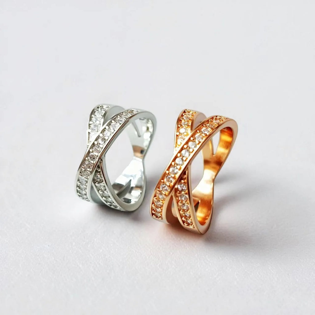 Silver and rose gold metal cross ring with micro-inlaid zircon, showing geometric and heart-shaped design.