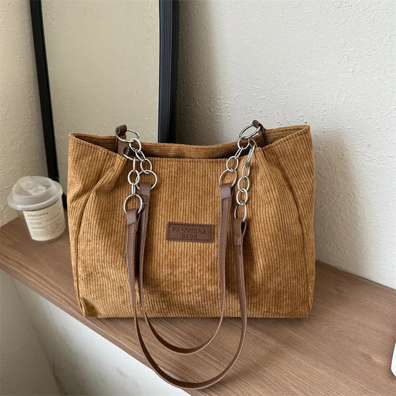 Corduroy one-shoulder tote bag with three-dimensional front pocket in street style design