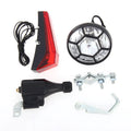Silver bicycle dynamo generator light kit showing generator unit, wiring, and connectors for front or rear mounting.