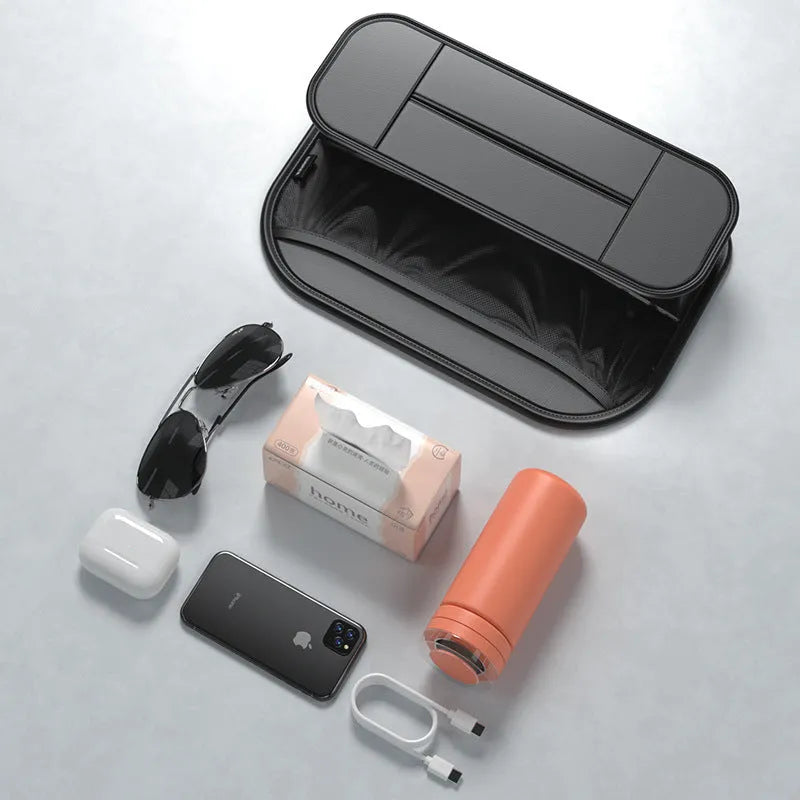 Black leather storage bag attached to the back of a car seat for organisation.