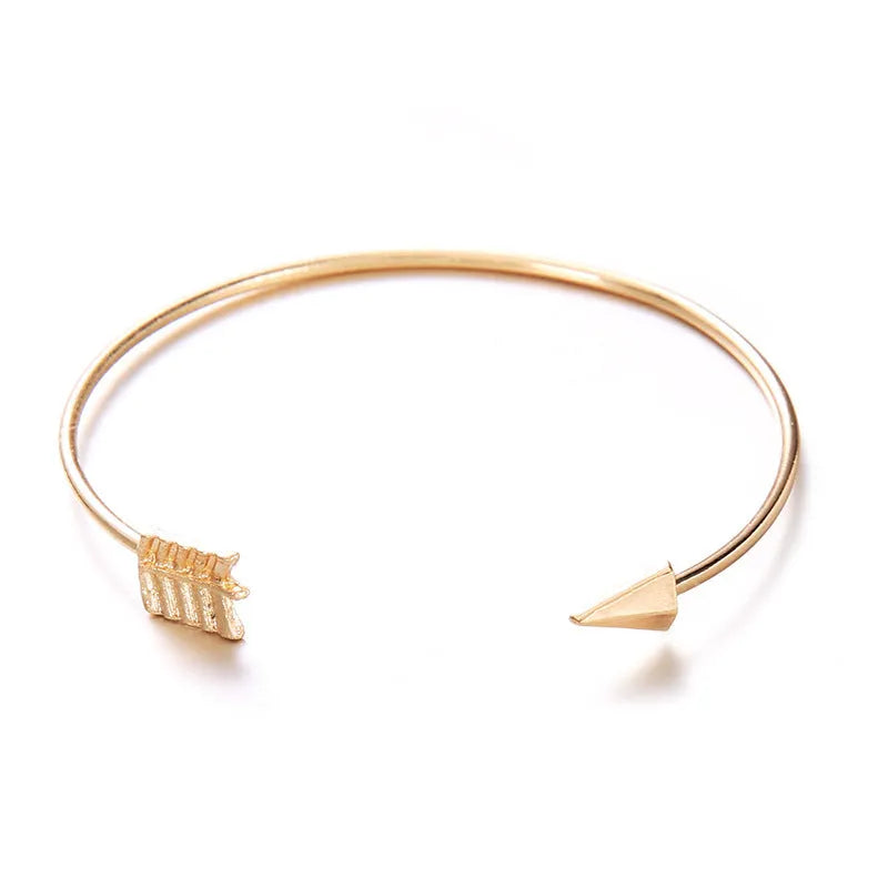 Gold women's cuff bracelet with arrow knot design on alloy electroplated band