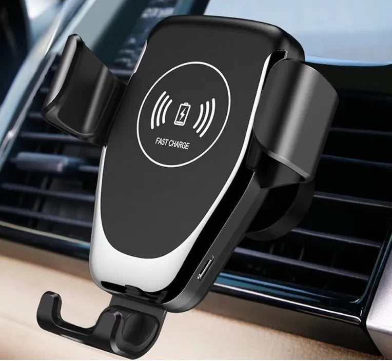 Black wireless car charger mounted on a car vent, holding an iPhone.