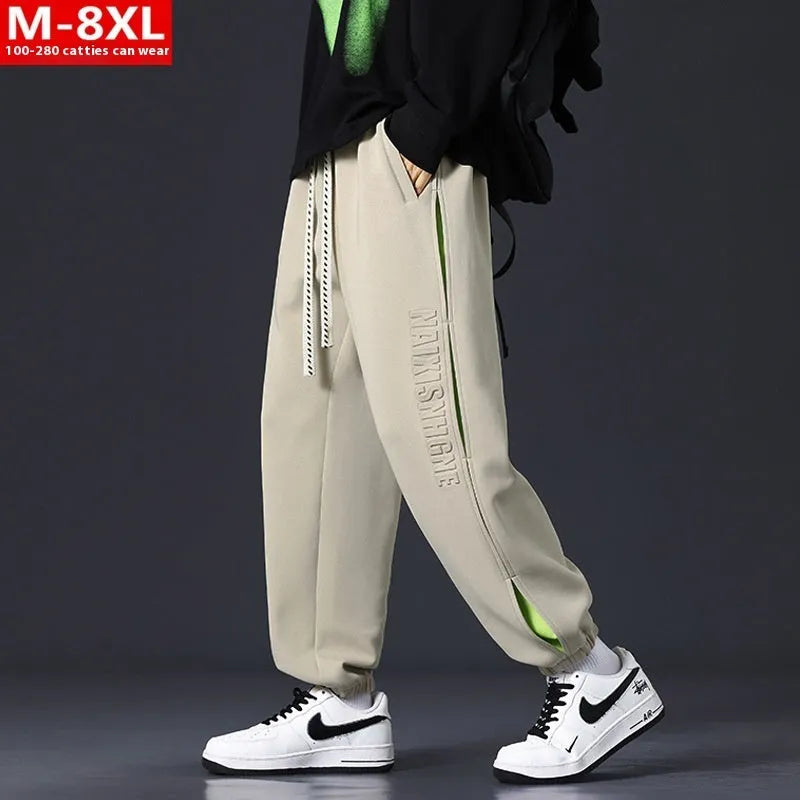 Men's loose-fit cotton trousers with stitching print design and ankle band in grey green.