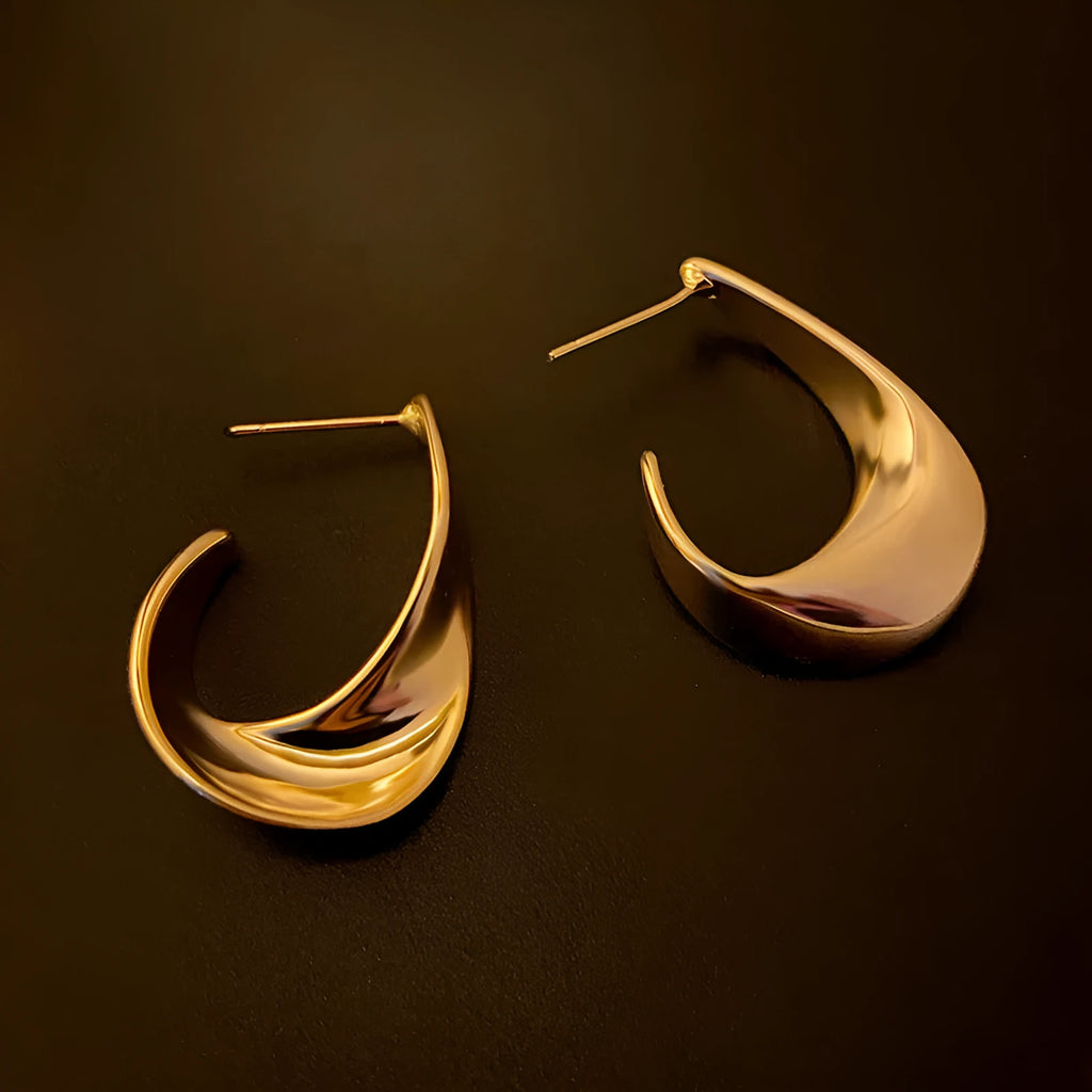 Twisted geometric metal earrings with circular elements in gold or silver electroplated finish