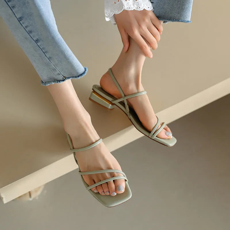 Women's flat strap open-toe Roman sandals in microfiber with a square toe, shown in a neutral colour.