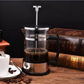 Small glass pour-over coffee maker with stainless steel filter, 350ml capacity.