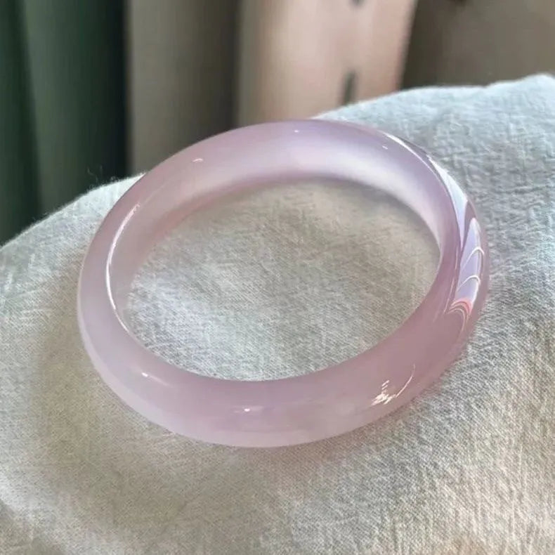 Natural agate wide tyre bracelet in pink colour, showing smooth bead design and internal diameter size.