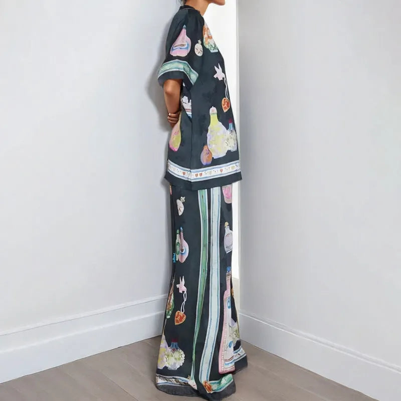 Women's black casual two-piece set with cartoon animation print, cardigan sleeve top, and matching trousers