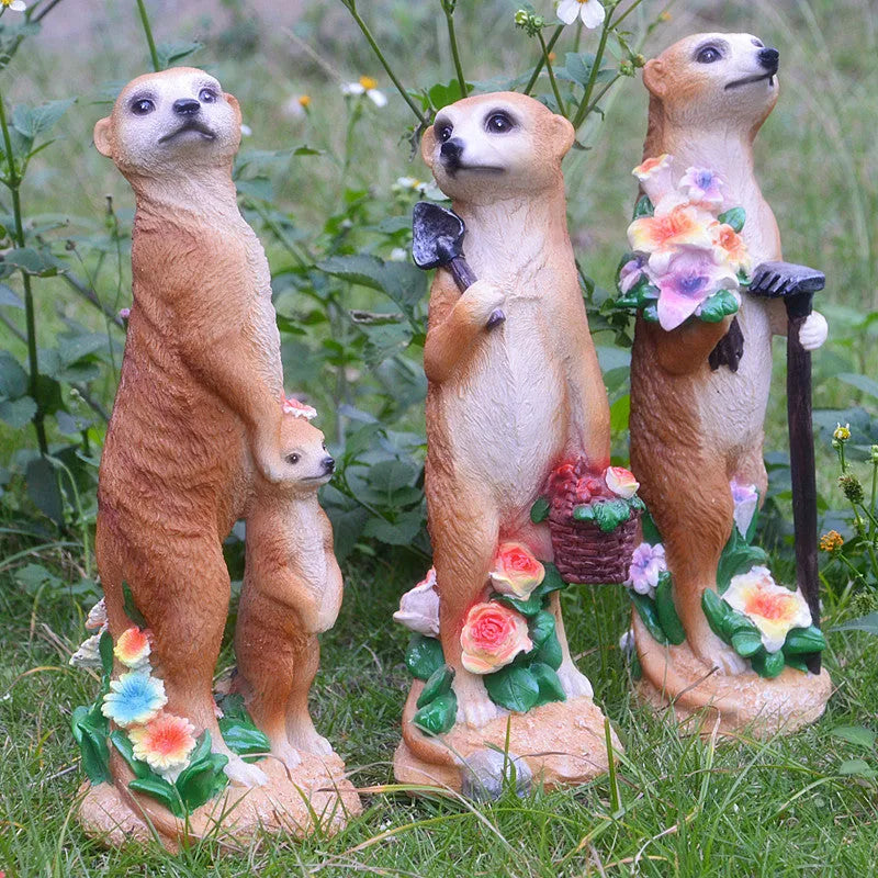 Three straw hat mongoose resin ornaments: mother and son, with rake, and with shovel figurines.
