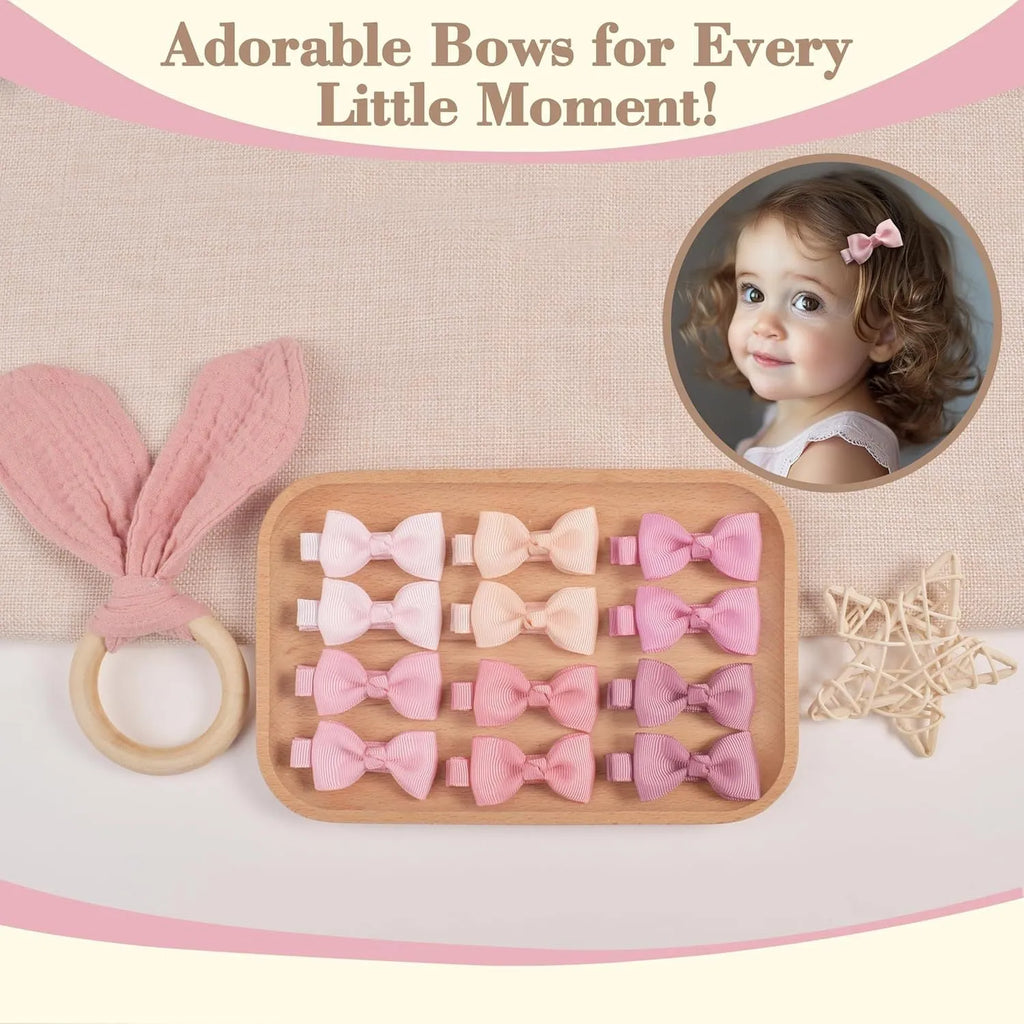 Assortment of pastel-coloured baby hair barrettes and bows laid out on a white background.