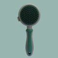 Green and pink 2-in-1 silicone cat grooming brush showing slicker brush and massager sides