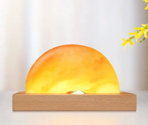 Natural crystal salt lamp with beech wood base featuring integrated wireless phone charging.
