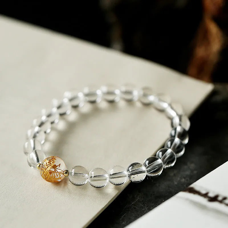 Geometric obsidian black agate and white crystal bracelet with golden dragon bead on adjustable cord.