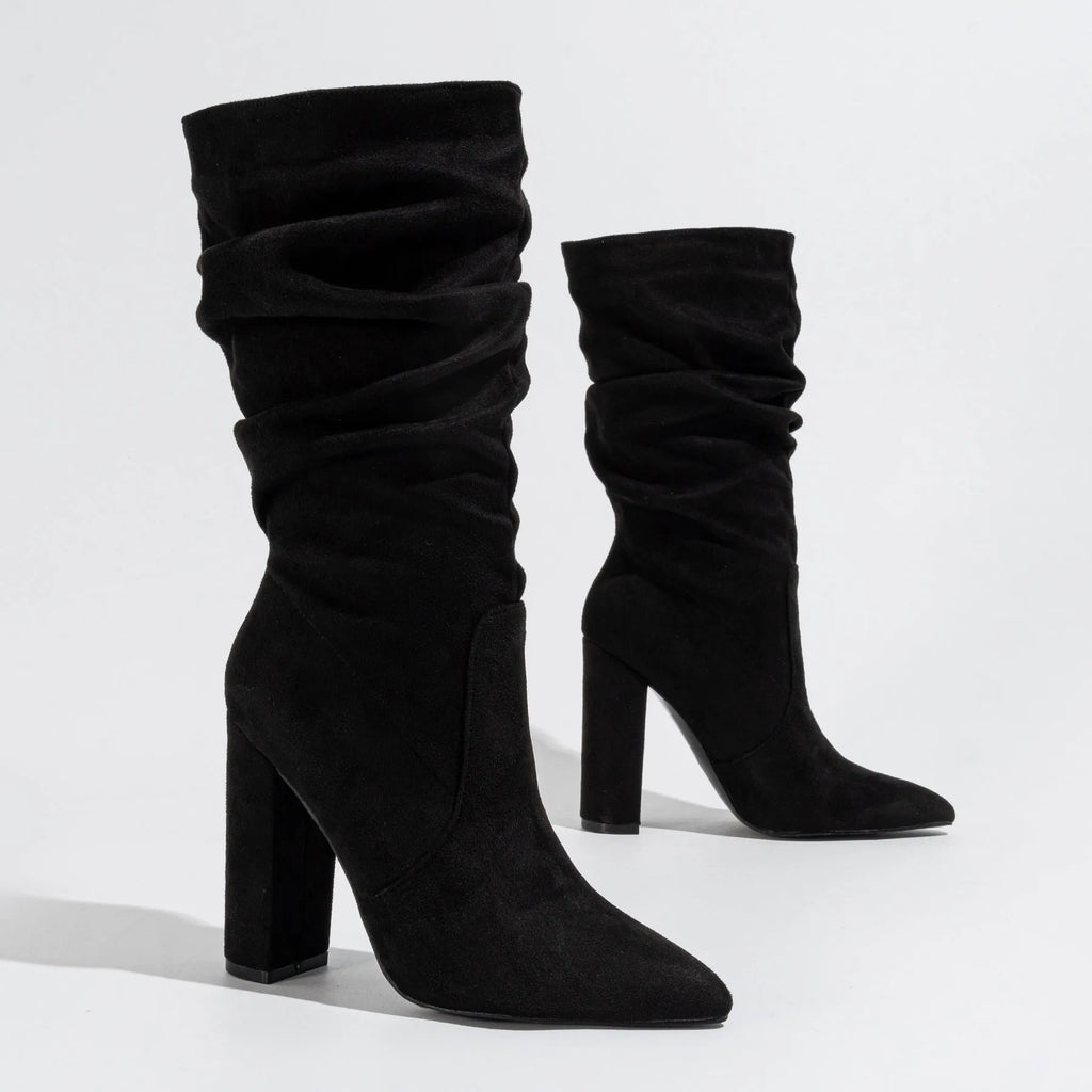 Women's black suede chunky heel boots with pointed toe and middle calf length.