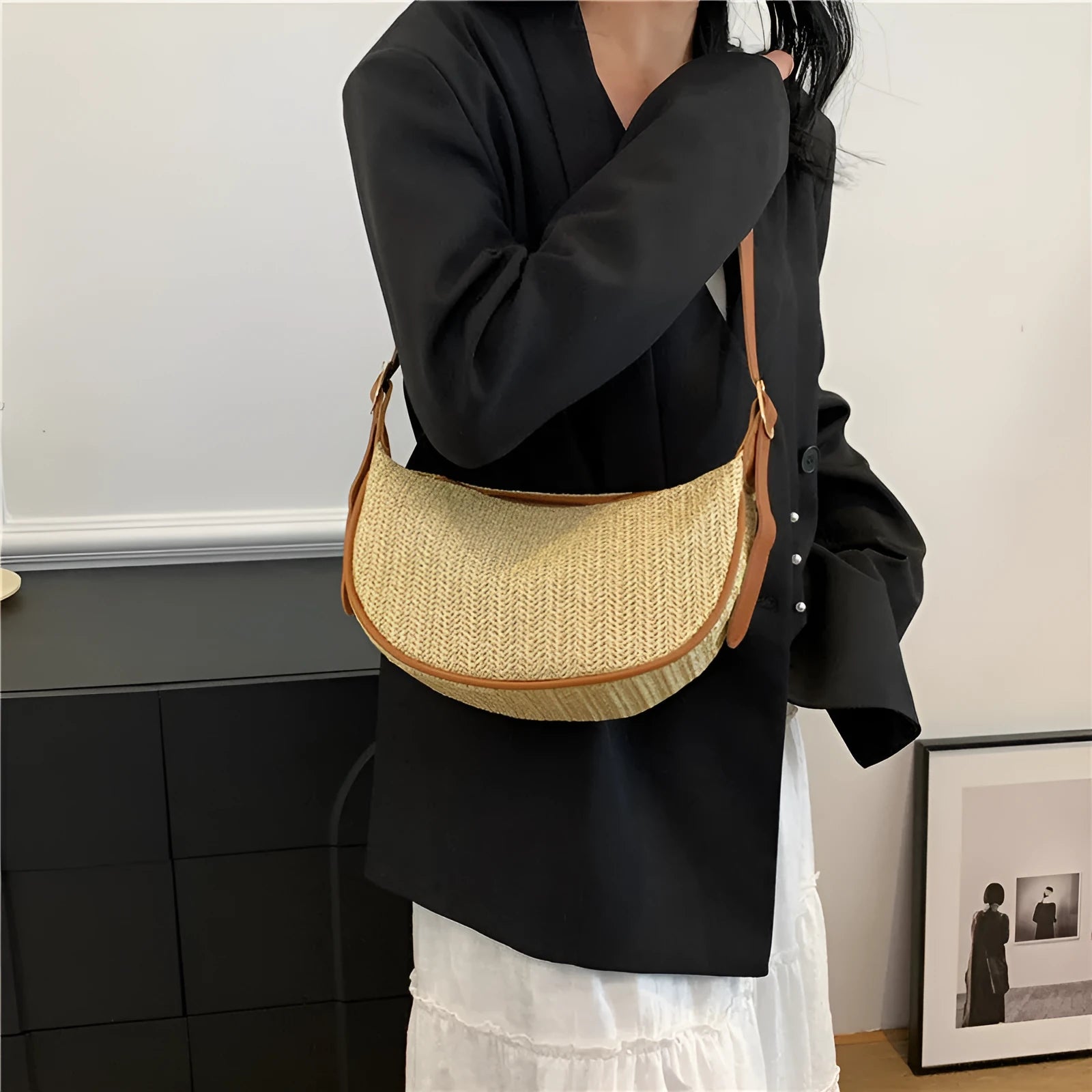 Women's woven straw crossbody bag with a single strap and internal organisation pockets.