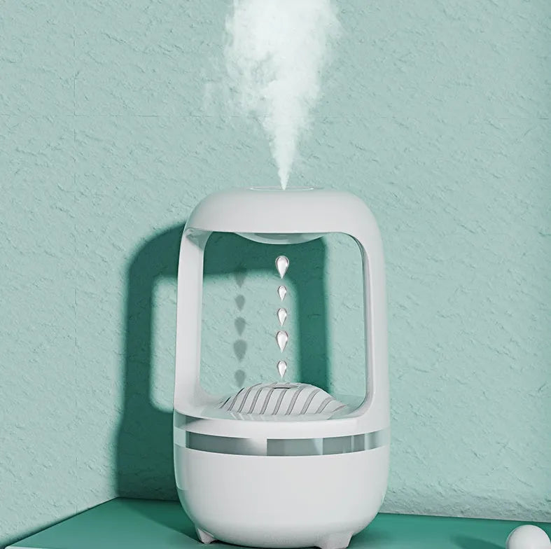 White anti-gravity humidifier showing water drop backflow effect with USB cable connection