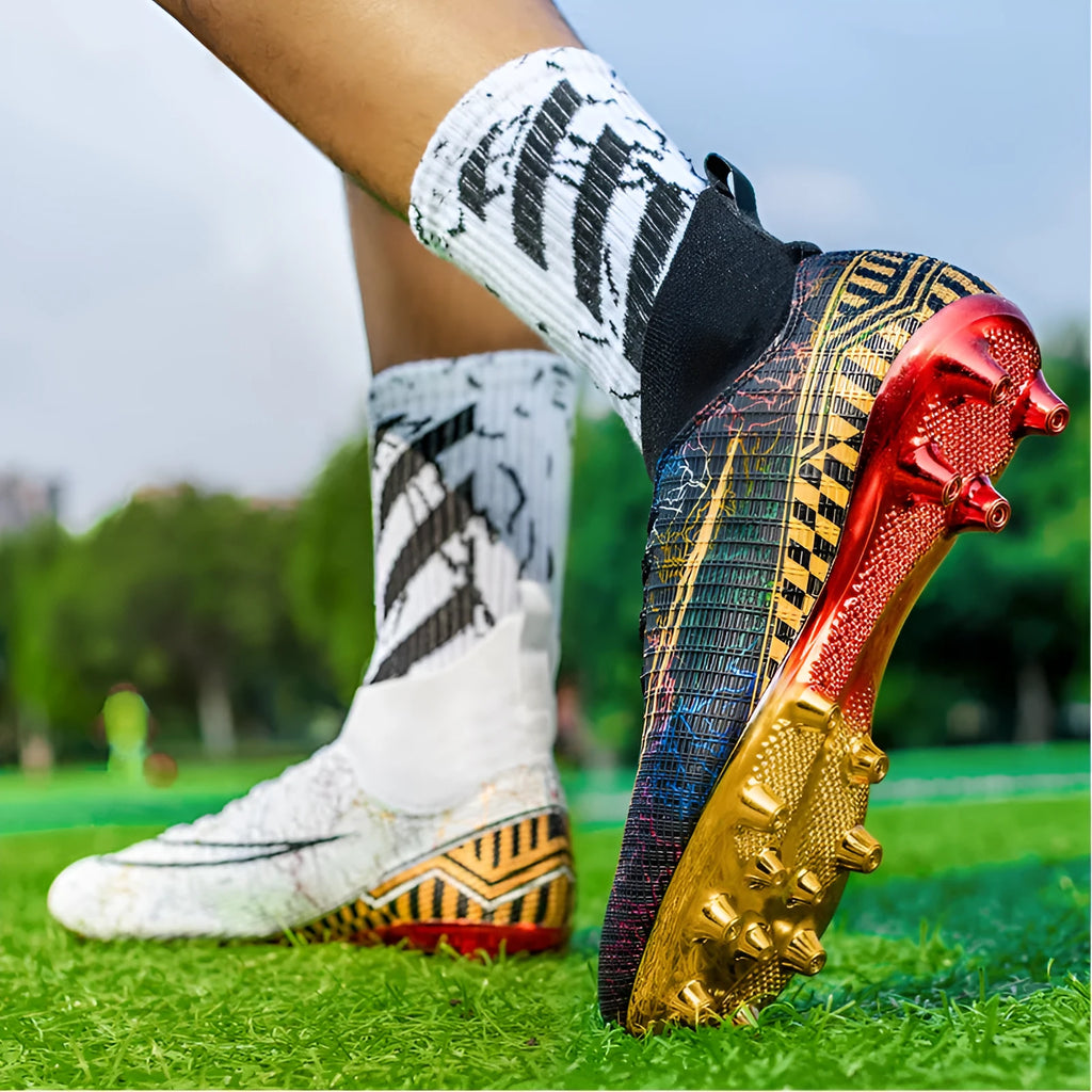 Men's high-top white soccer training shoes with a gold plated sole bottom on artificial grass.