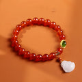 Chinese style women's bracelet with natural amber, red agate beads and gold Buddha charm