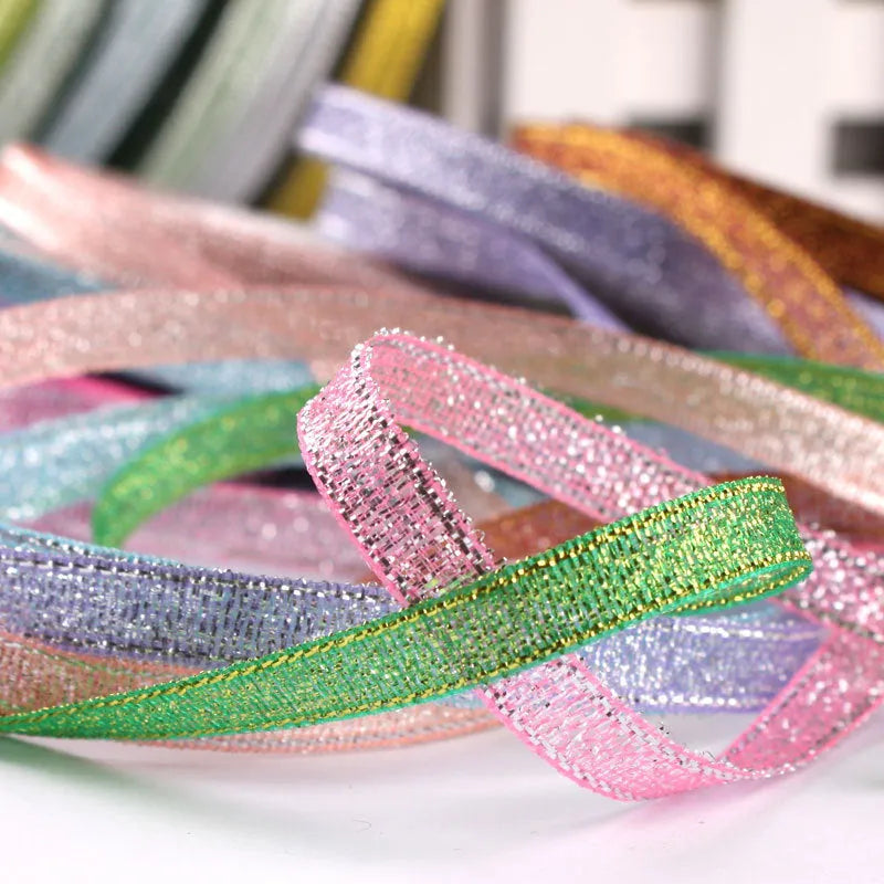 Polyester ribbon roll in various colours including gold leaf and silver, showing 0.6cm width and 22 metre length