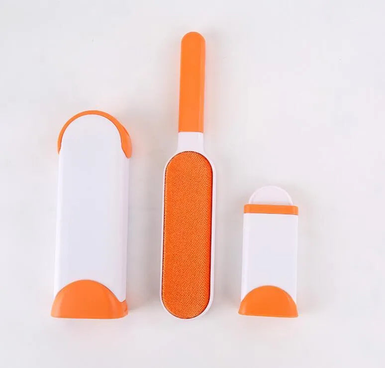 Blue reusable pet hair removal brush with self-cleaning base on a grey sofa.