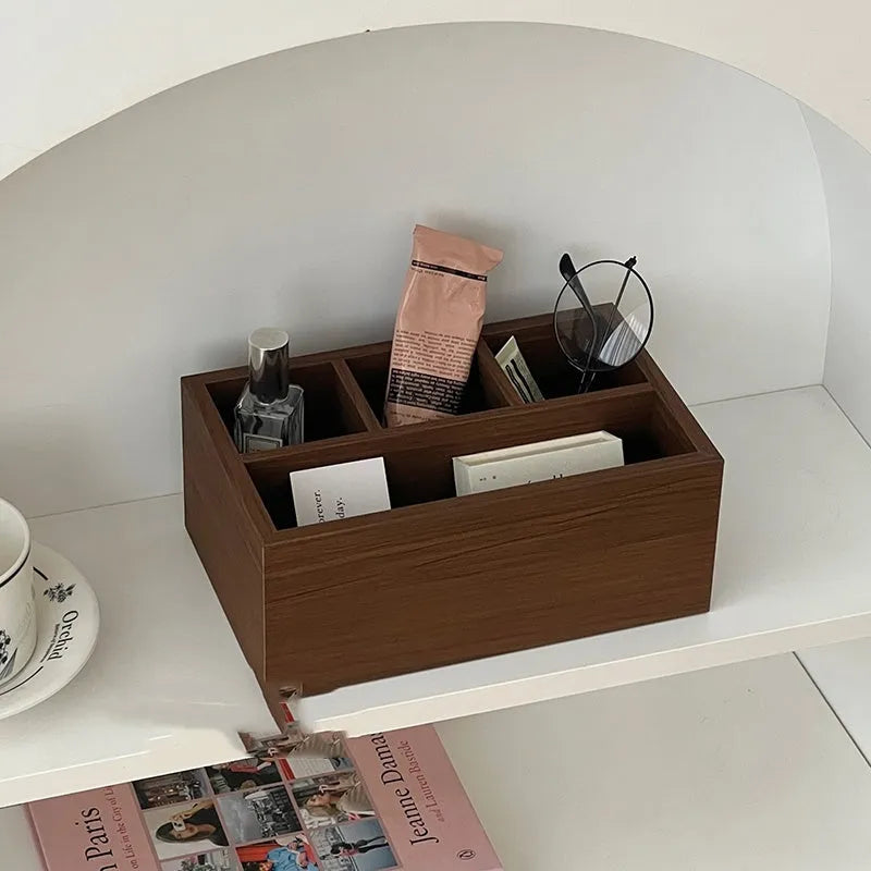 Retro wood desktop grid storage box with four short cells on a desk organising pens and sundries