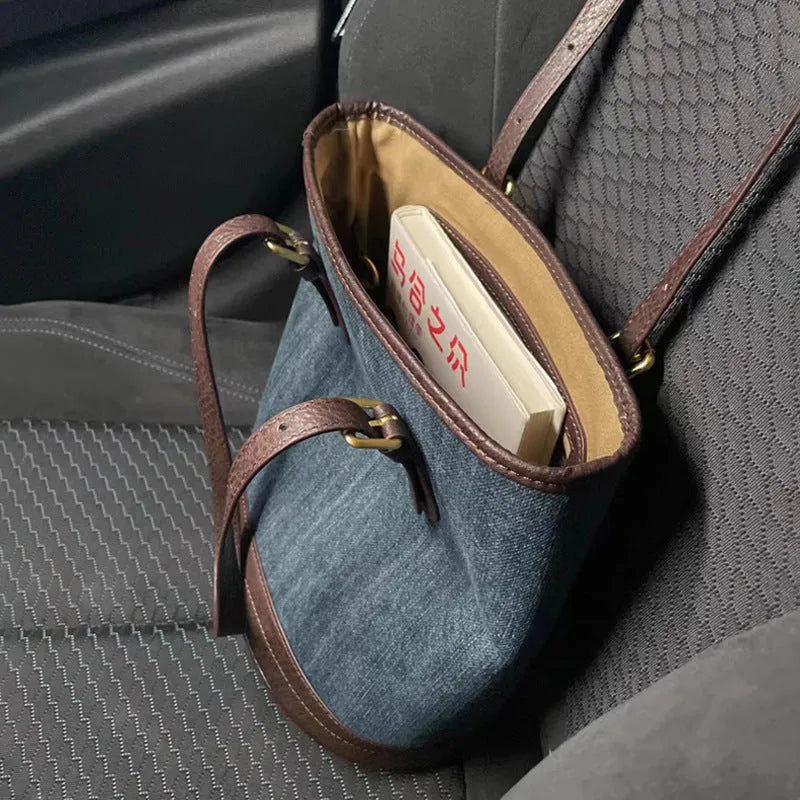 Large denim patchwork retro bucket handbag with a one-shoulder strap.