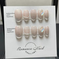 Set of short, blush-coloured handmade false nails displayed in sizes XS, S, M, L