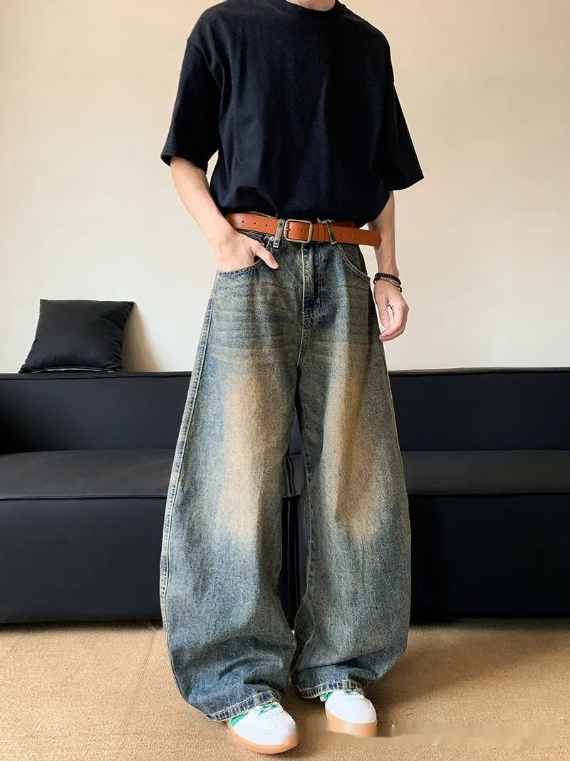 Men's retro blue distressed denim wide-leg trousers showing slim fit and vintage detailing