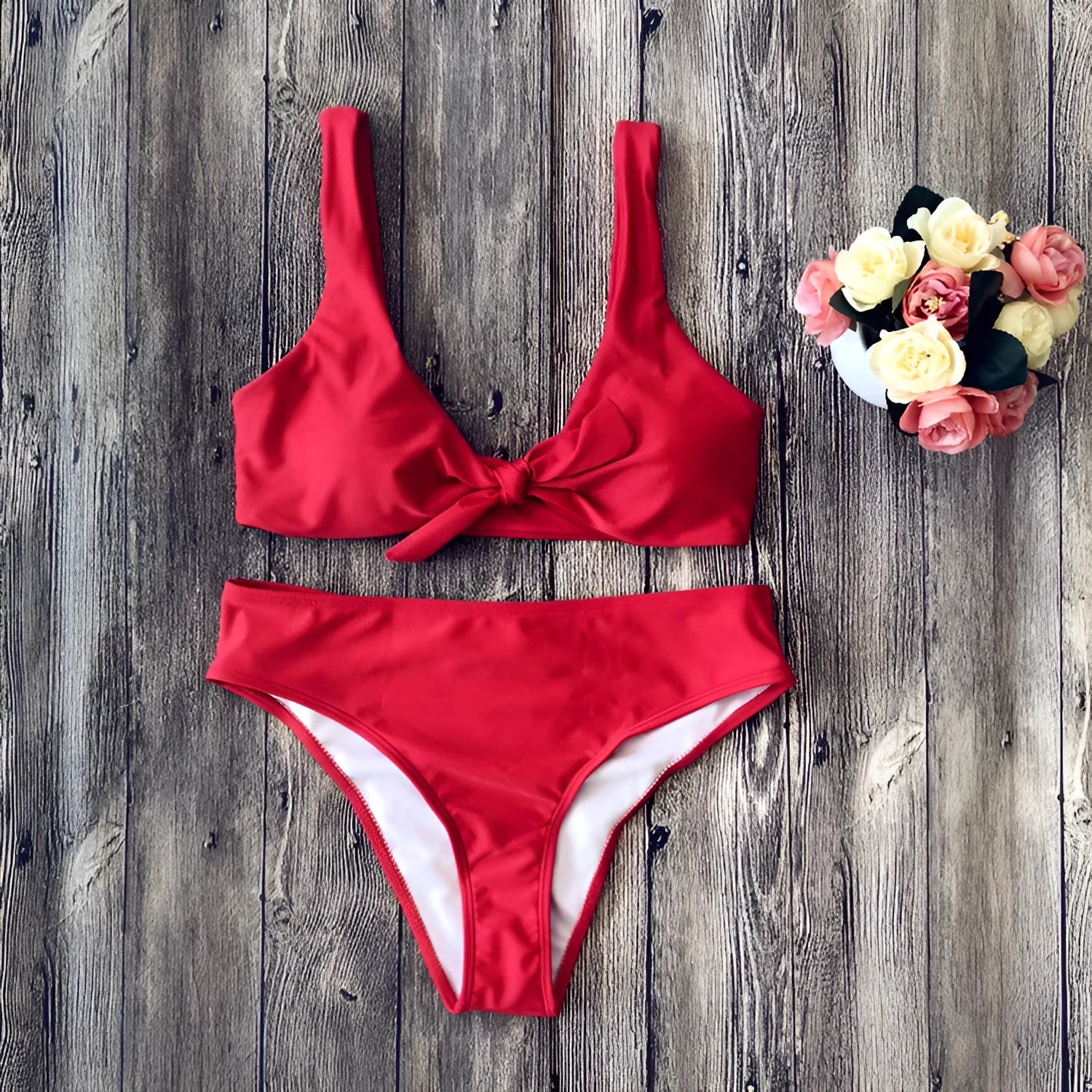 Women's solid colour bikini swimsuit set in polyester, showing sleeveless bra and matching briefs.