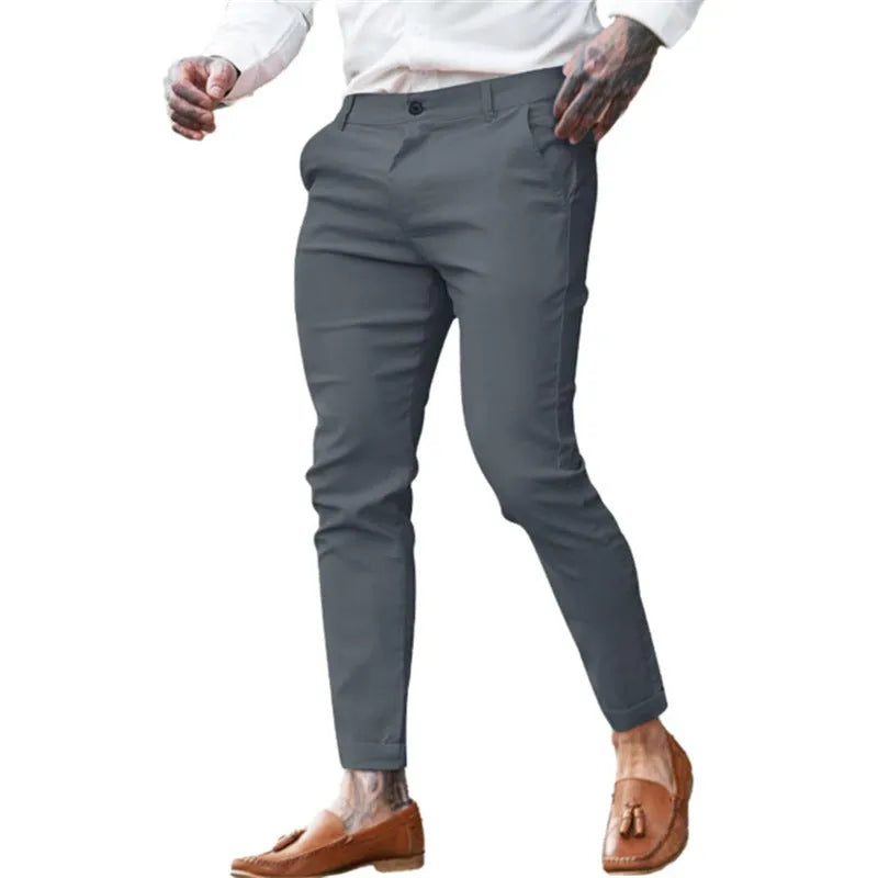 Men's slim fit stretch cotton pencil pants in a solid colour on a model.