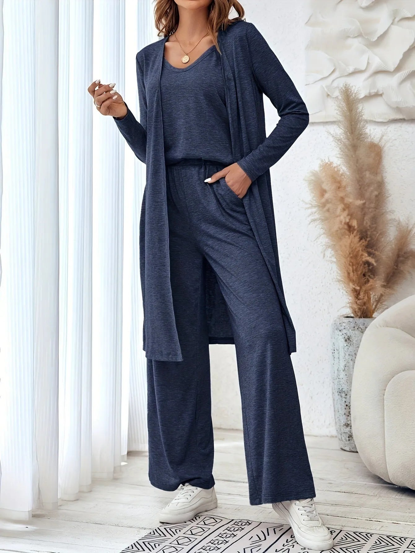 Blue women's casual co-ord suit with long sleeve cardigan and trousers on a hanger