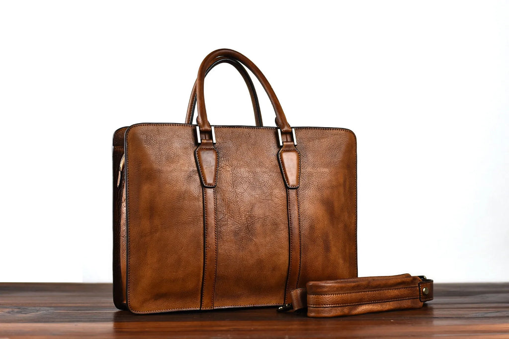 Men's brown leather horizontal business handbag with zipper closure shown from the front.