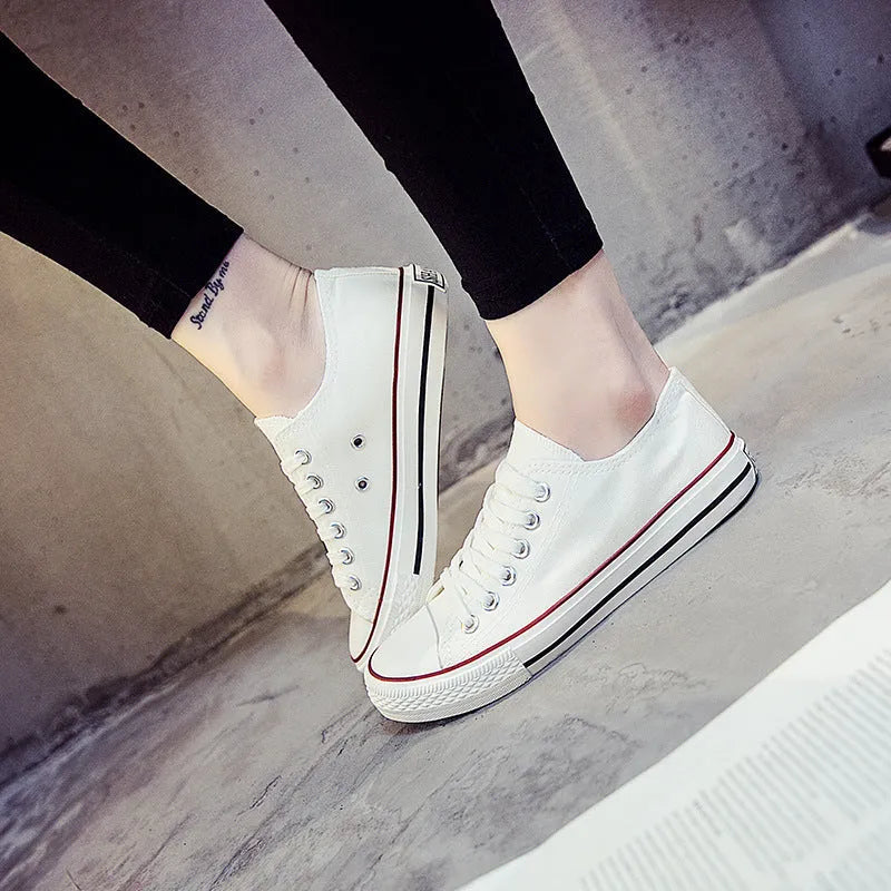 Women's solid colour canvas casual shoes showing available colours: all-black, black, white-black, and white-red.