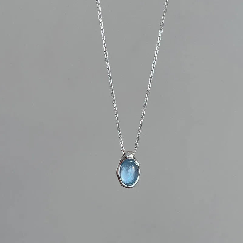 Navy blue water drop pendant necklace with cross chain in electroplated platinum colour finish