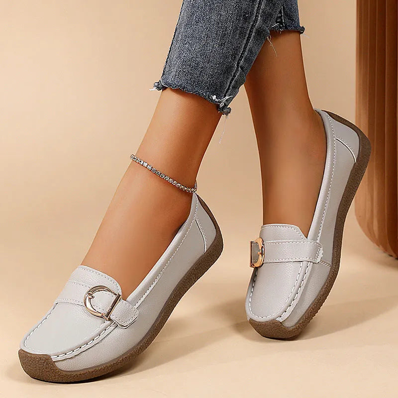 Women's beige casual flat loafers with round toe and slip-on design on a soft sole.