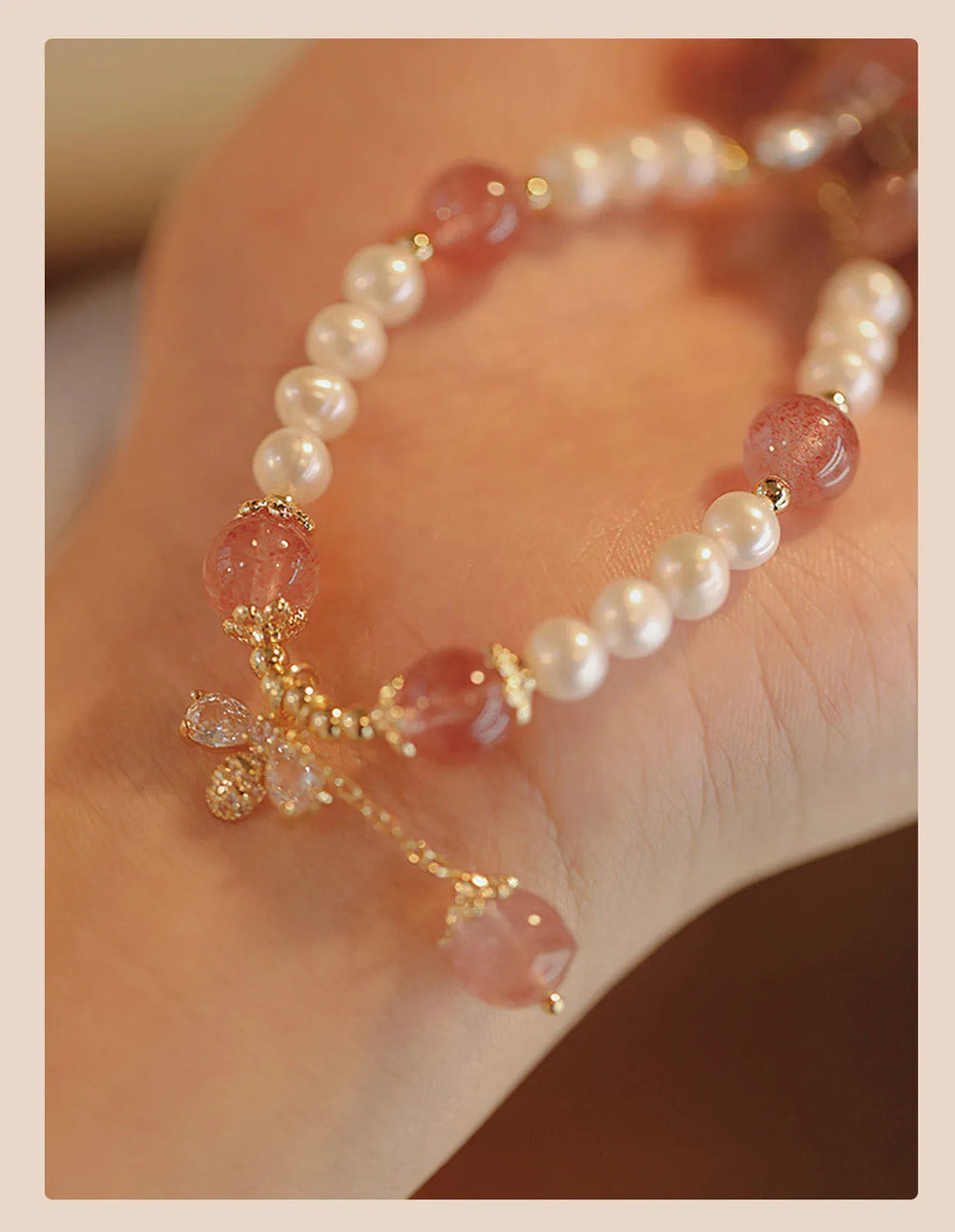 Women's strawberry quartz crystal bracelet with bow detail on wrist