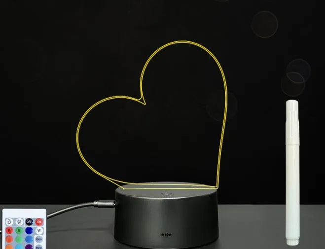 Black 3D acrylic LED night light and message board with stylus on a desktop